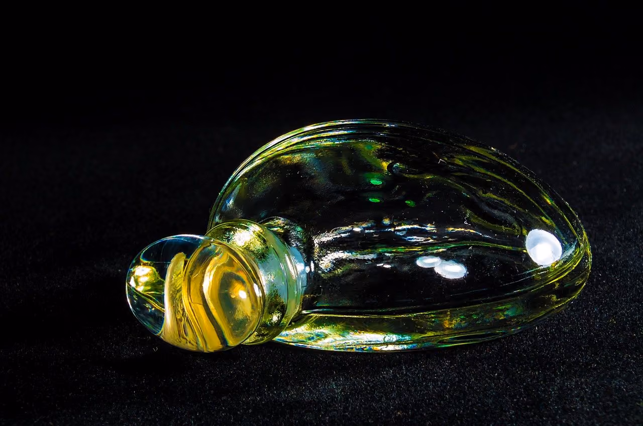 After: Green and yellow glass object lit against a black background